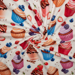 Bomuldsjersey med cupcakes i primærfarven råhvid