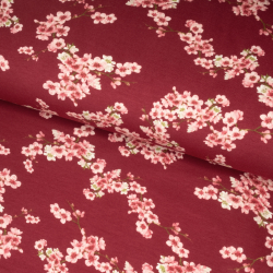 Økologisk jogging med blomstrende kirsebærtrægrene på cerise baggrund