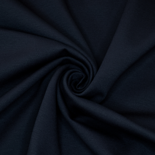 Ensfarvet puntostof i farven mørk navy, hvor stoffet er vredet rundt i en cirkel for at vise fald og skygger