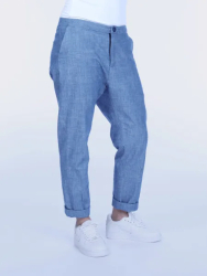 Person iført lyseblå bukser og hvide sneakers.