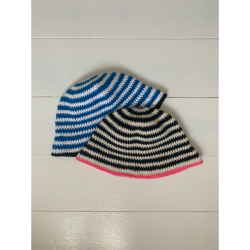 Billede af stribede, hæklede bøllehatte, der ligger på gulvet. Den øverste bøllehat har sorte og råhvide striber med pink kant, og den nederste bøllehat har blå og hvide striber med sort kant.